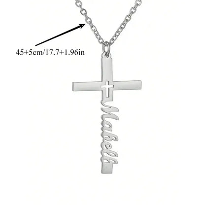 Silver cross-shaped necklace with 'Mabell' engraving on a white background. Arrow points to chain and says 17.7 inches + 1.96 inches.